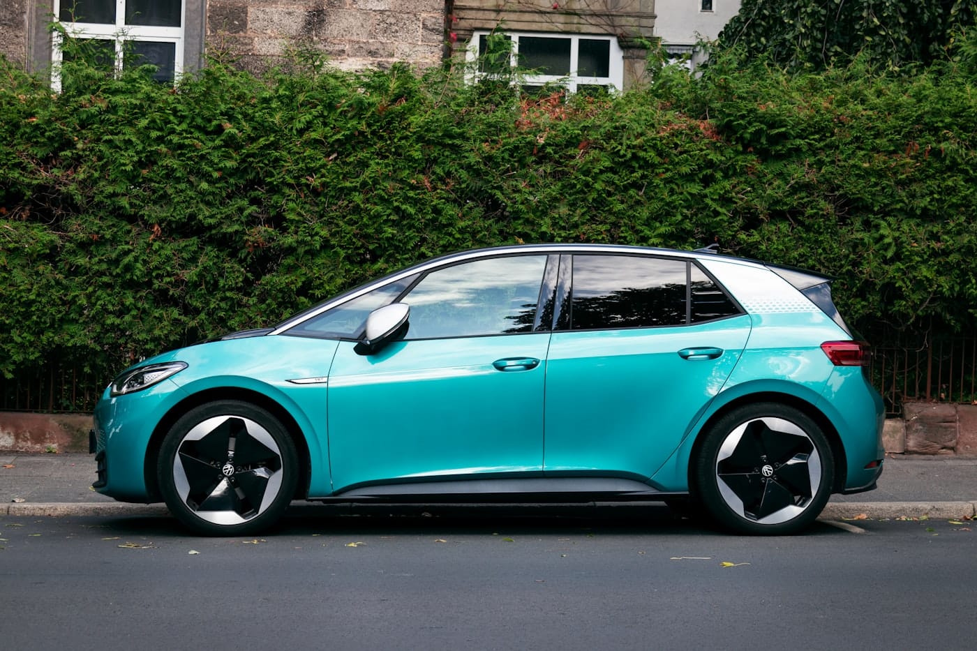 a blue car parked on the side of the road