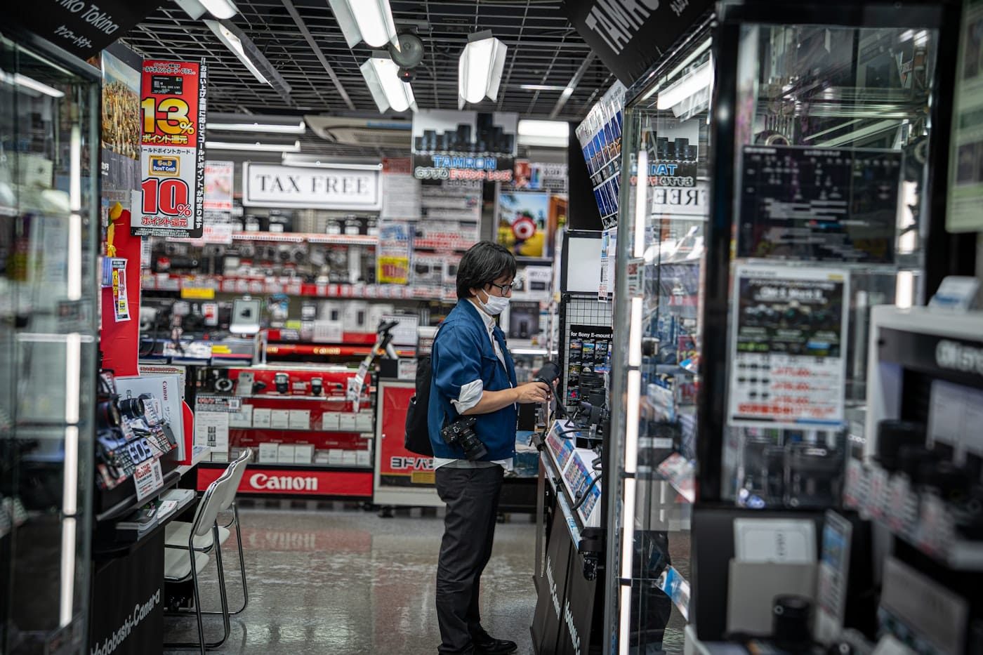 Person browsing electronics in a brightly lit store